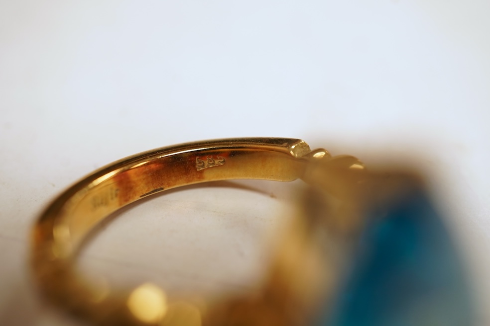 A cubic zirconia and diamond ring, set with a marquise-shaped blue cubic zirconia, to shoulders set with brilliant-cut diamonds, mounted in gold, size Q1/2, stamped 585, gross weight 8 grams, Condition: minor discolorati
